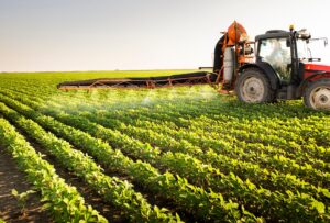 Tractor,Spraying,Pesticides,On,Soy,Field,With,Sprayer,At,Spring