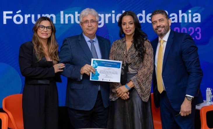 Retrato de dois homens e duas mulheres, recebendo um certificado juntos, no Fórum Integridade Bahia